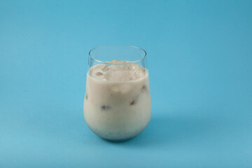 Misutgaru Latte (Misugaru Latte) - Healthy Korean multi-grain cocktail. Popular homemade breakfast drink. Protein shake made from fried multi-grain powder. Blue background, copy space