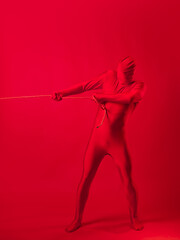 the red man drags something on a rope, a concept of labor and anxiety.