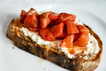 Strawberries and cream cheese on sourdough bread