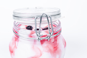 Ice cream. Ice cream in a glass jar with fruit. Side view of ice cream in a glass jar. An open jar of ice cream.