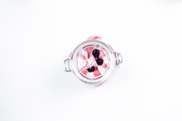Ice cream. Ice cream in a glass jar top view. Ice cream with berries and fruit topping in a jar on a white background