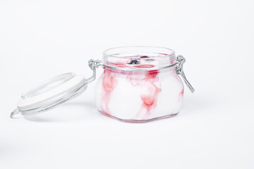 Ice cream. Ice cream in a glass jar with fruit. Side view of ice cream in a glass jar. An open jar of ice cream.