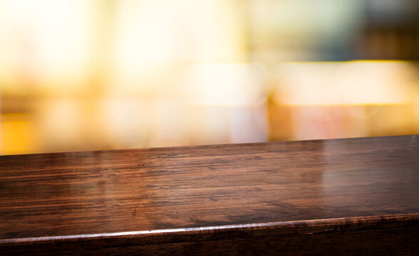bar nightclub background.Empty diagonal brown wooden table with blur bar restaurant bokeh lights,banner mockup template for display of product
