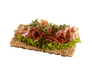 Variety of mini sandwiches with cream cheese, vegetables and salami.