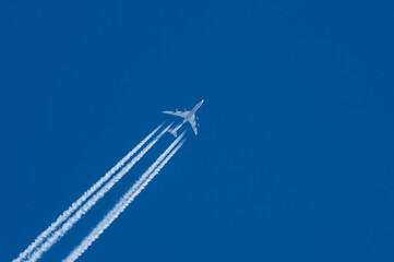 jet plane with a white plume on a blue sky
