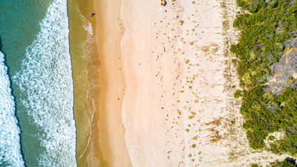 Surf on a sunny beach. Coromandel, New Zealand.