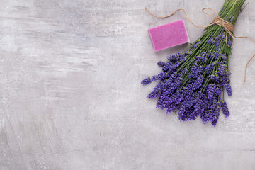 Obraz na płótnie Canvas Grooming products and fresh lavender bouquet on white wooden table background.