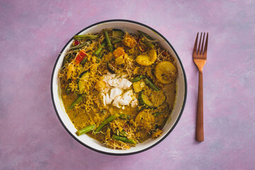 vegan yellow curry with mixed vegetables tofu and vermicelli noodles, healthy plant-based food