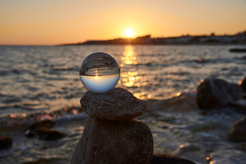 Sunset with crystal ball over the sea