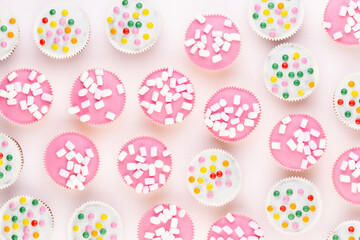 Colorful cupcakes on a white background.