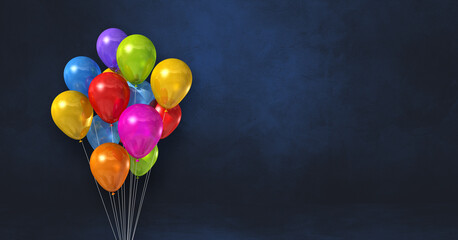 Colorful balloons bunch on a black wall background. Horizontal banner. © daboost
