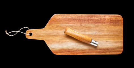 Wooden cutting board and pocket knife isolated on black