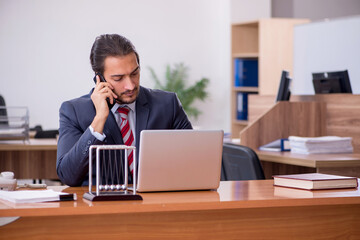 Young man businessman employee sitting in the office