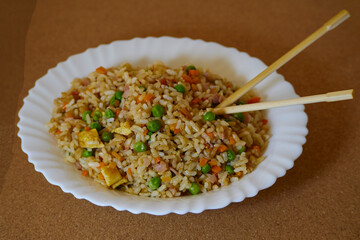 Delcious Special Fried rice in a white dish and Asian Chopsticks