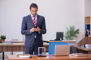 Young man businessman employee sitting in the office