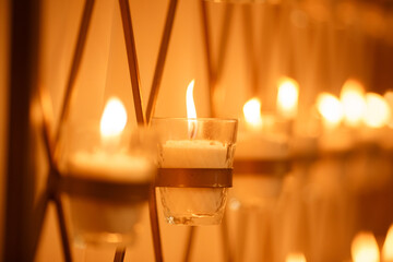 Many burning candles with shallow in church