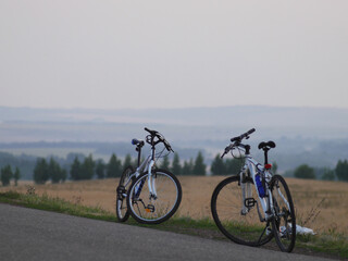 Obraz premium Two bicycles stand in a beautiful landscape.