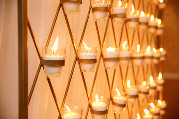 Many burning candles with shallow in church