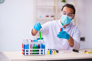 Young male chemist working in the lab