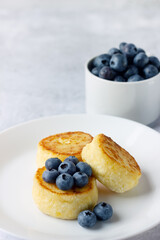 Cottage cheese pancakes with blueberries, healthy Breakfast. Russian, Ukrainian cuisine food.