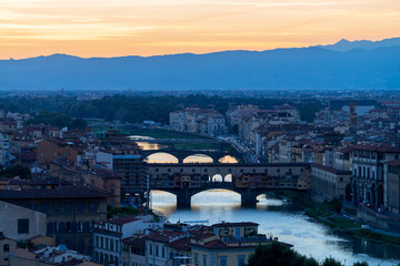 Fototapeta na wymiar Florence or Firenze sunset aerial cityscape. Panorama view from Michelangelo park square. Ponte Vecchio bridge, Palazzo Vecchio and Duomo Cathedral. Tuscany, Italy