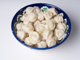Dumplings in the national dish. Russian and Asian traditional cuisine. Studio photography