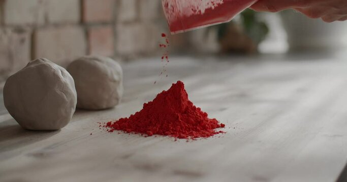 Ceramist pours dry dye for kneading colored clay, nerikomi pottery, potter's workshop, 4k 60p Prores HQ 10 bit