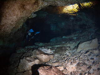 Scuba diving in a salactite underwater cave (Cenote Tajma Ha, Playa del Carmen, Quintana Roo, Mexico)