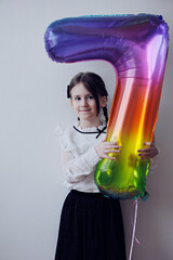 Cute little girl wiht happy birthday ballon