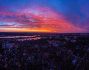 Aerial view of dramatic sunset sky above the city at dusk.