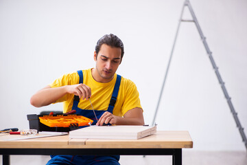 Young male carpenter working indoors