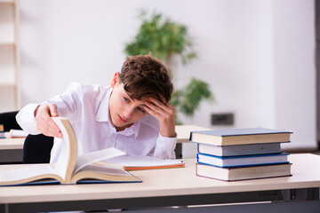 Schoolboy preparing for exams in the classroom