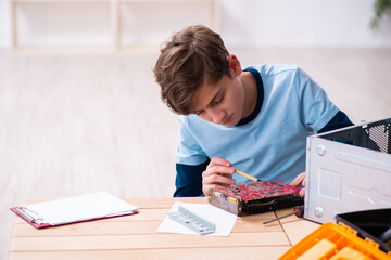 Boy reparing computers at workshop