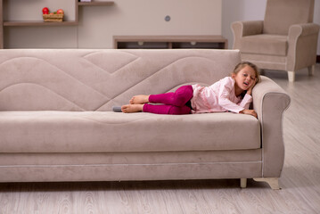 Small girl staying alone at home