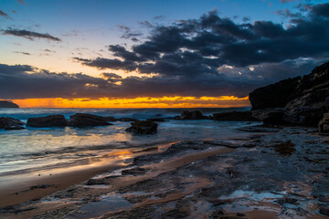 Sunrise seascape with rain clouds on the horizon
