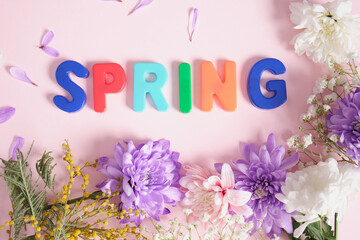 inscription spring and flowers on pink background