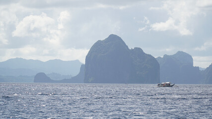 Green lush karst mountains rising out of the ocean on Palawan Island near El Nido, Philippines