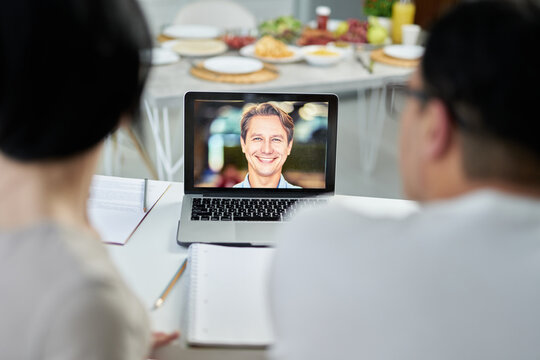 Family Assistant. Latin Couple Making Video Call To Marriage Counselor Using Laptop, Looking At Screen, Talking On Webcam