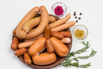 Sausages of different varieties on ceramic plate.