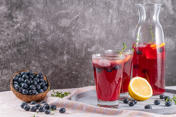Fototapeta na wymiar Fresh blueberry summer mojito cocktail. Blueberry lemonade or sangria on kitchen countertop