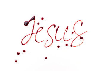 Name Jesus written with blood isolated on white background. Top view. Palm Sunday, Good Friday,...