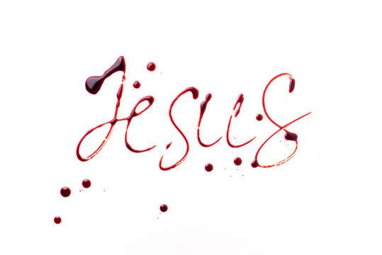 Name Jesus written with blood isolated on white background. Top view. Palm Sunday, Good Friday, Easter concept, Christ resurrection. Christianity symbol and faith.