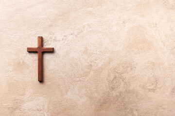 Wooden cross on marble background. Reminder of Jesus sacrifice and Christ resurrection. Easter...