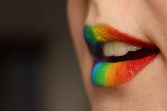 A closeup of rainbow colored lips in the colors of LGBT flag. A concept for speaking about gay rights - Powered by Adobe