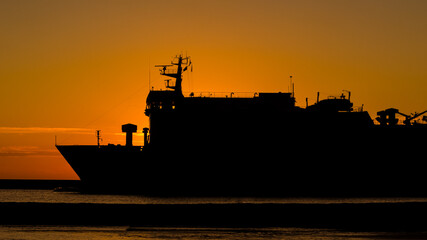 Fototapeta premium PASSENGER FERRY - The ship sails to sea at sunrise 