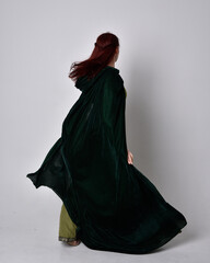 full length portrait of red haired girl wearing celtic, green medieval gown with fantasy velvet...