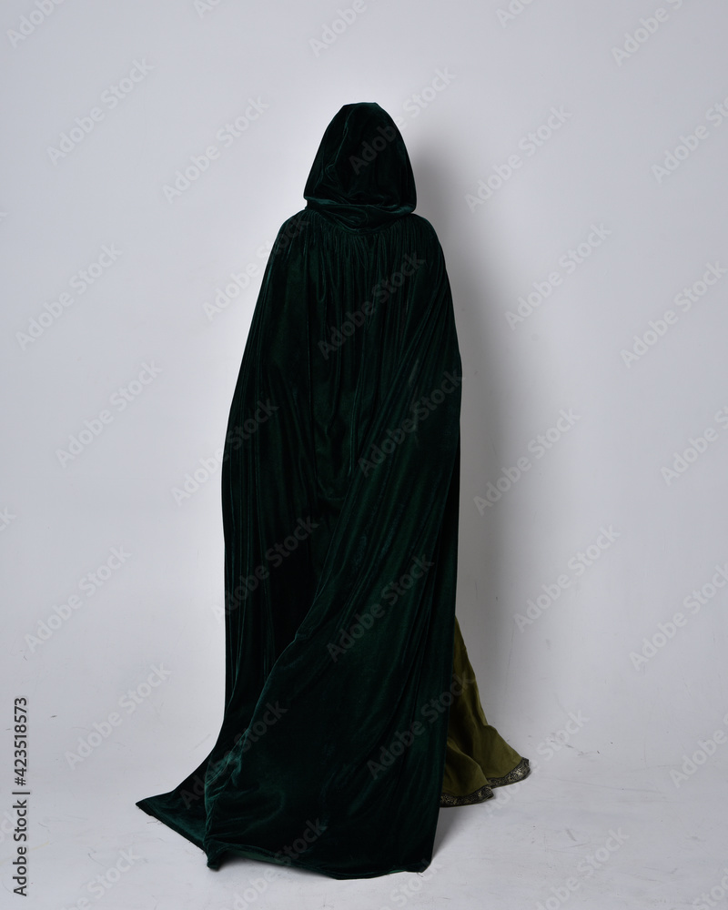 Sticker full length portrait of red haired girl wearing celtic, green medieval gown with fantasy velvet cloak. Standing pose isolated against a studio background.