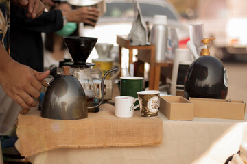 A hand catch coffee kettle that is on the table to brewing drip coffee.
