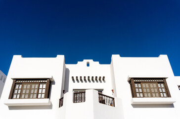 The view of top floor of house in the tropical garden with balcony and roof