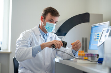 Fototapeta na wymiar Male scientist scanning samples in the laboratory.